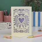 A detailed floral laser cut card with heart shape in the centre and two banners, one above with "Kindness" and one below with "is everything". 