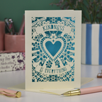 A detailed floral laser cut card with heart shape in the centre and two banners, one above with "Kindness" and one below with "is everything". 