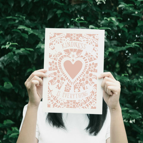 A unique inspirational print with "kindness is everything" in banners around a heart.  - 