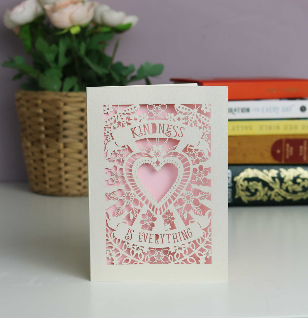 Pretty in pale pink "Kindness is everything" papercut card. Cut from cream card with a baby pink insert. Shows a cutout heart surrounded with flowers and butterflies.