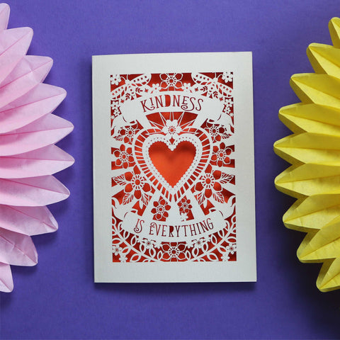 Beautiful papercut card showing a heart, flowers and butterflies. With "Kindness is everything" on banners above and below the heart. Cream card and orange background. - A5 (large) / Orange