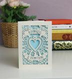 "Kindness is everything " shown on two banners above and below a beautiful cutout heart, with flowers and butterflies. Lovely pale blue insert with cream card.