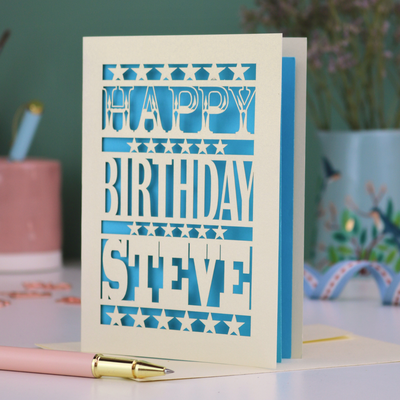 A laser cut personalised birthday card that says "Happy Birthday Steve" in bold text with star design.