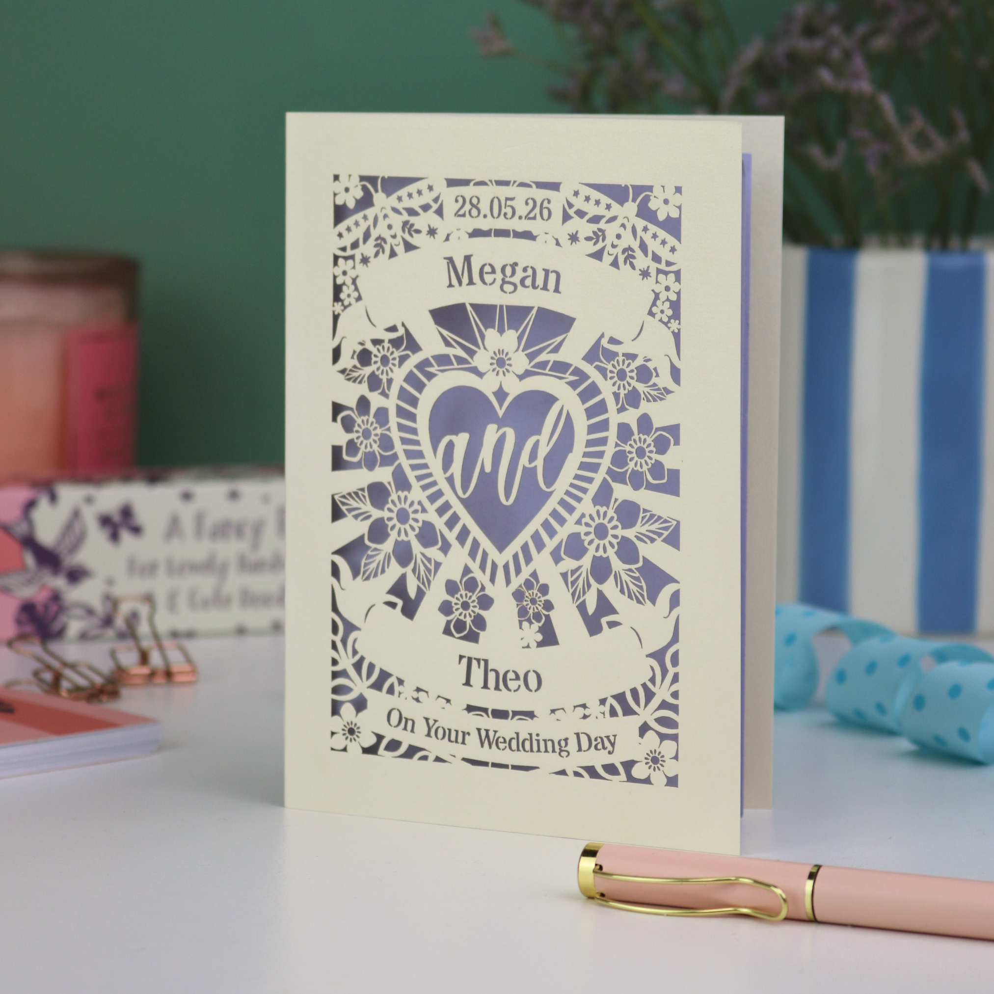Wedding card with personalised names and date on a decorative background