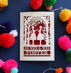 A personalised Valentine's day card with a laser cut design of two women making a heart shape, with a blank space for a personal message, and brightly coloured pom-pom decorations around it.