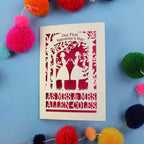 A personalised lesbian first Valentine's day card with a laser cut design of two women making a heart shape, with a blank space for a personal message, and brightly coloured pom-pom decorations around it.