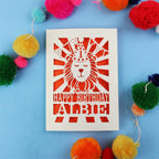 Special papercut 1st Birthday card with lion design and colourful pom-poms on a blue background