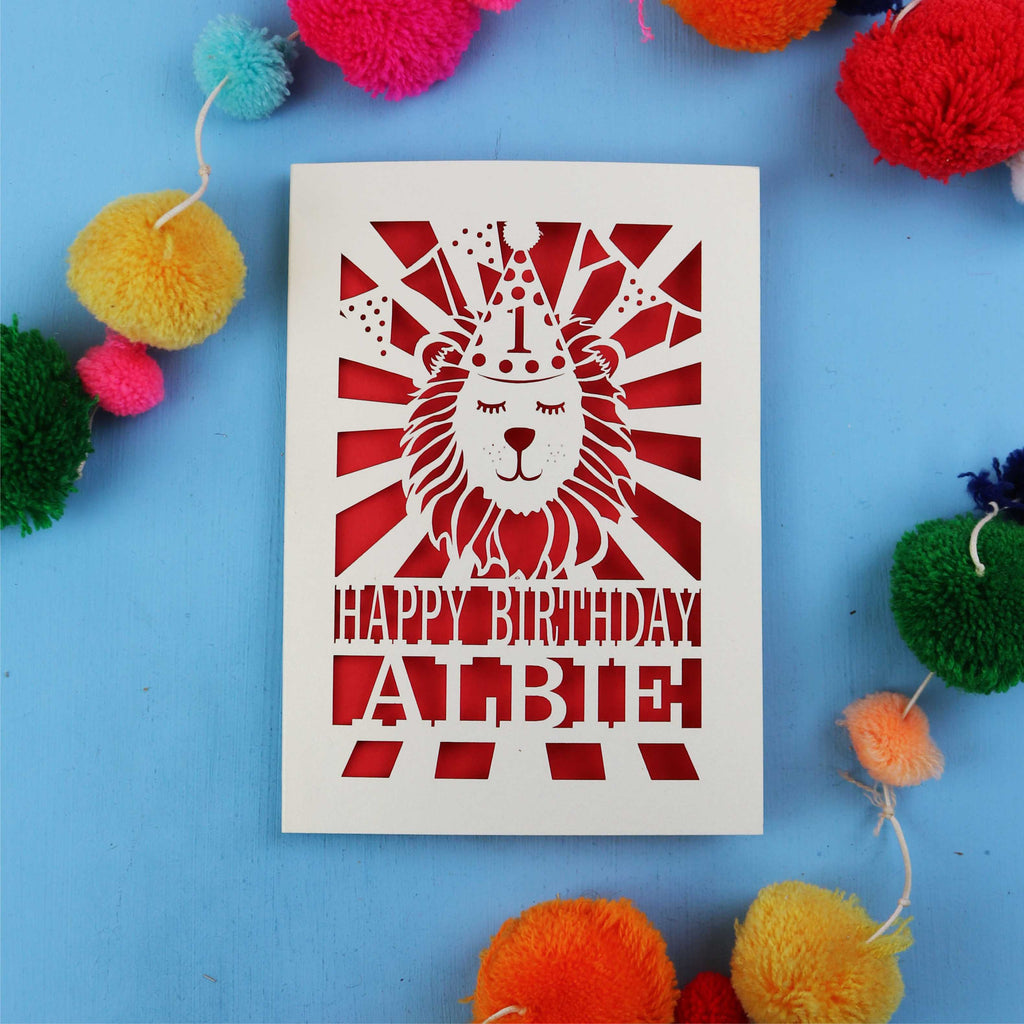 Unique 1st Birthday card with lion design and colourful pom-poms on a blue background