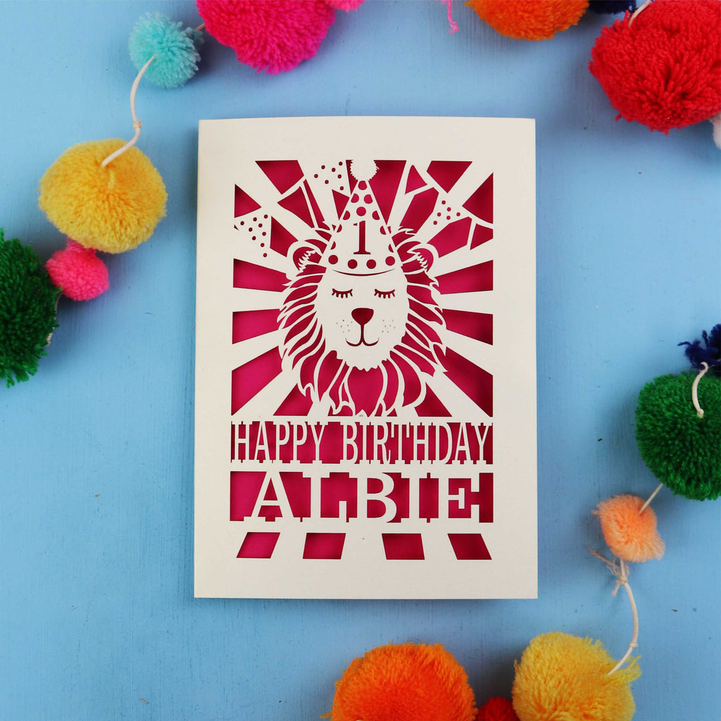 Special 1st Birthday card with lion design and colourful pom-poms on a blue background