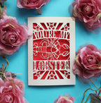 A paper cut Valentine's card that says "You're My Lobster" with a cut out design of a lobster