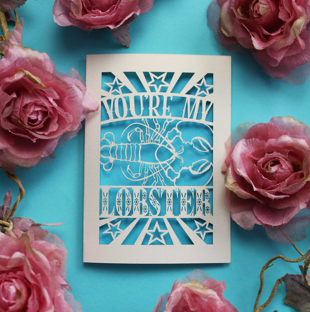 A papercut Valentine's card that says "You're My Lobster" with a cut out design of a lobster