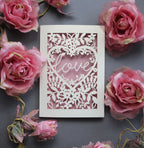 Laser cut engagement card with 'love' inside a floral heart design 