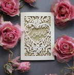 Laser cut engagement card with 'love' inside a floral heart design 