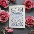 Laser cut engagement card with 'love' inside a floral heart design 