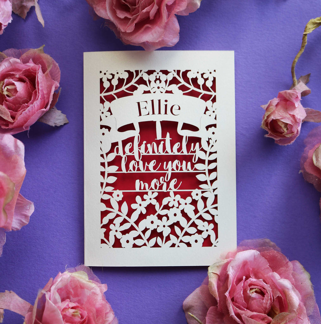 A laser cut Valentine's card that says "I definitely love you more"