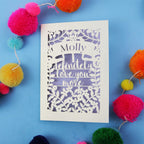 A laser cut Valentine's Card with the words "Molly, I definitely love you more" 