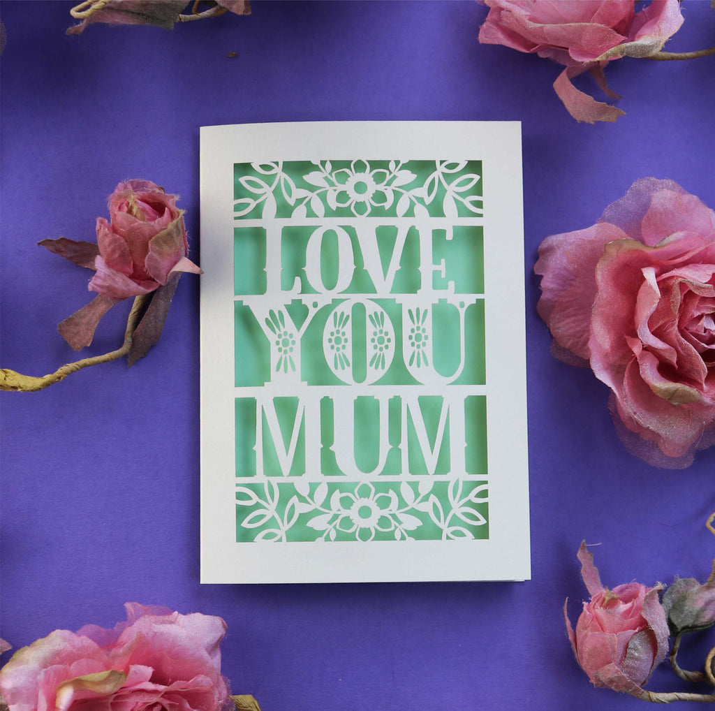 A paper cut Mothers day card that says "Love you mum"
