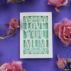 A paper cut Mothers day card that says "Love you mum"