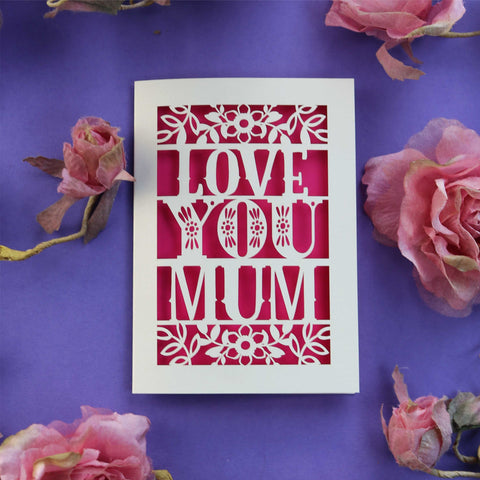 A laser cut Mother's Day card that says "Love You Mum" in cut out text