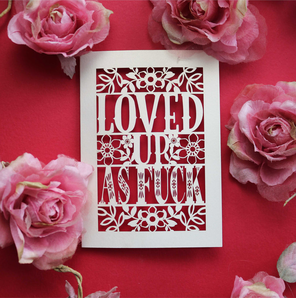 A cut out Valentine's card that says "Loved up as fuck"
