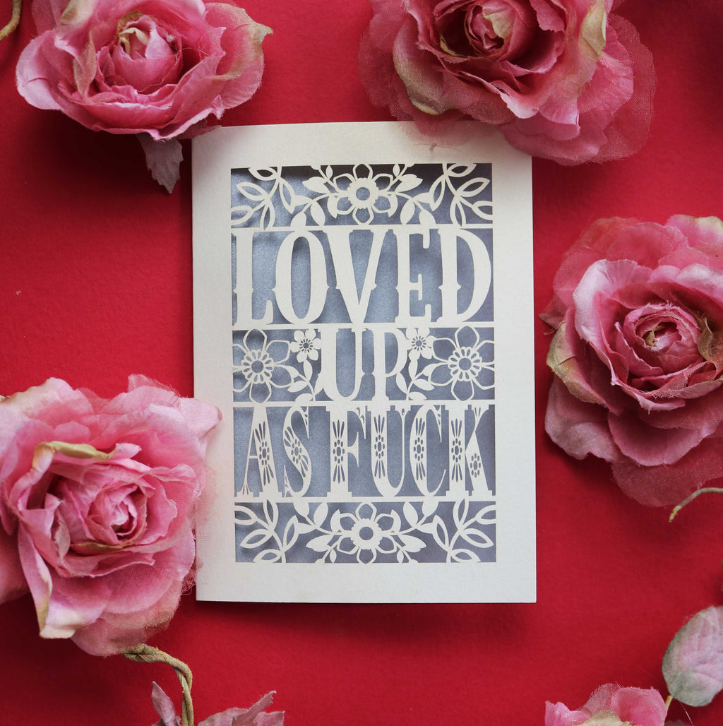 A papercut Valentine's Day Card, laser cut with the words "Loved up as fuck"