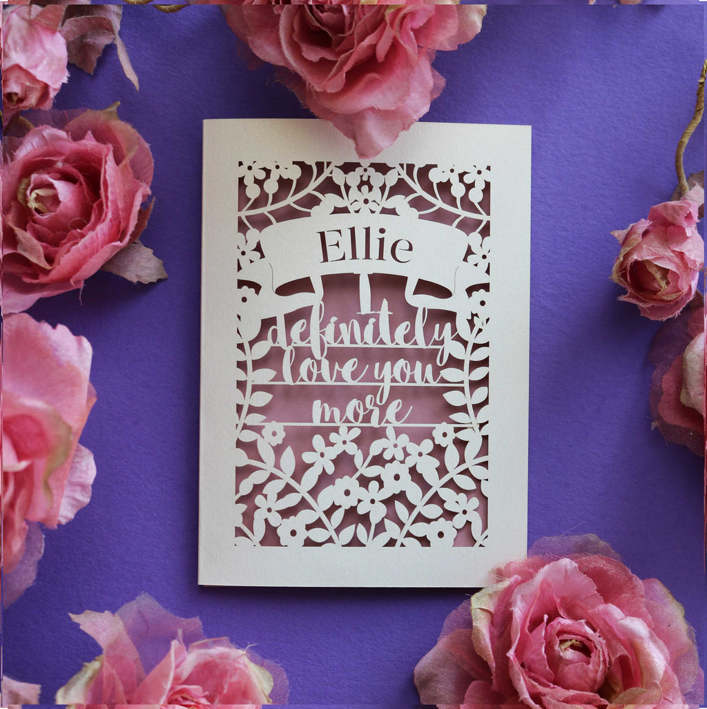 A laser cut Valentine's card that says "I definitely love you more"