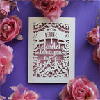 A laser cut Valentine's card that says "I definitely love you more"