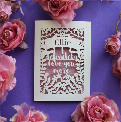 A laser cut Valentine's card that says "I definitely love you more" - A5 / Dusky Pink