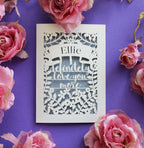 A laser cut Valentine's card that says "I definitely love you more"