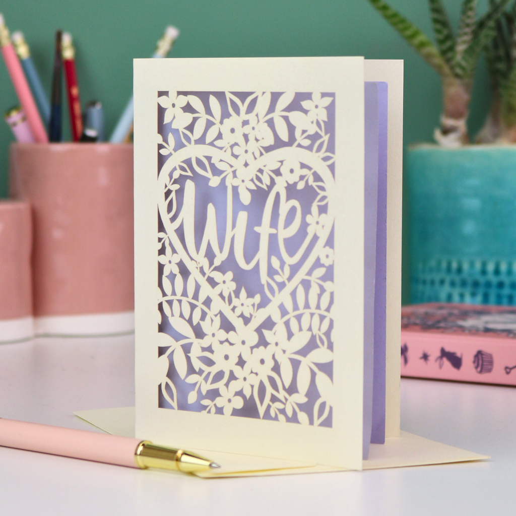 Luxury laser cut Card with 'Wife' design on a desk with stationery items