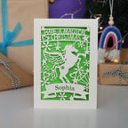 A personalised laser cut girls' Christmas card with a unicorn and the words "Have a magical Christmas, Name"