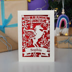 A personalised laser cut girls' Christmas card with a unicorn and the words "Have a magical Christmas, Name"