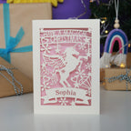 A personalised laser cut girls' Christmas card with a unicorn and the words "Have a magical Christmas, Name"