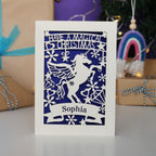 A personalised laser cut girls' Christmas card with a unicorn and the words "Have a magical Christmas, Name"