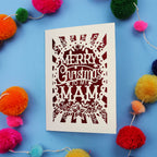 Laser cut Mam Christmas card with 'Merry Christmas to my Mam' text on a blue background with colourful pom-poms.