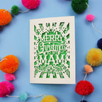 Laser cut Mam Christmas card with 'Merry Christmas to my Mam' text on a blue background with colourful pom-poms.