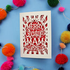 Laser cut Mam Christmas card with 'Merry Christmas to my Mam' text on a blue background with colourful pom-poms.
