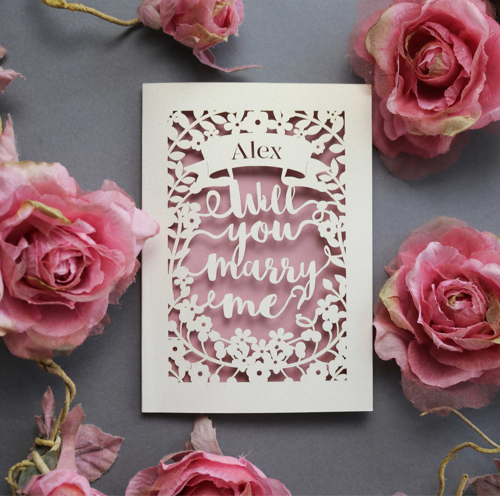 A paper cut wedding proposal card