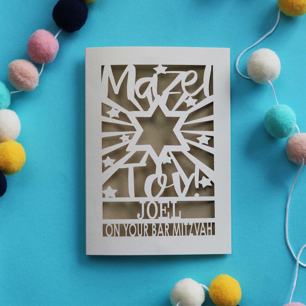 A personalised cut out Bar Mitzvah card that says "Mazel Tov! Name, on your Bar Mitzvah"