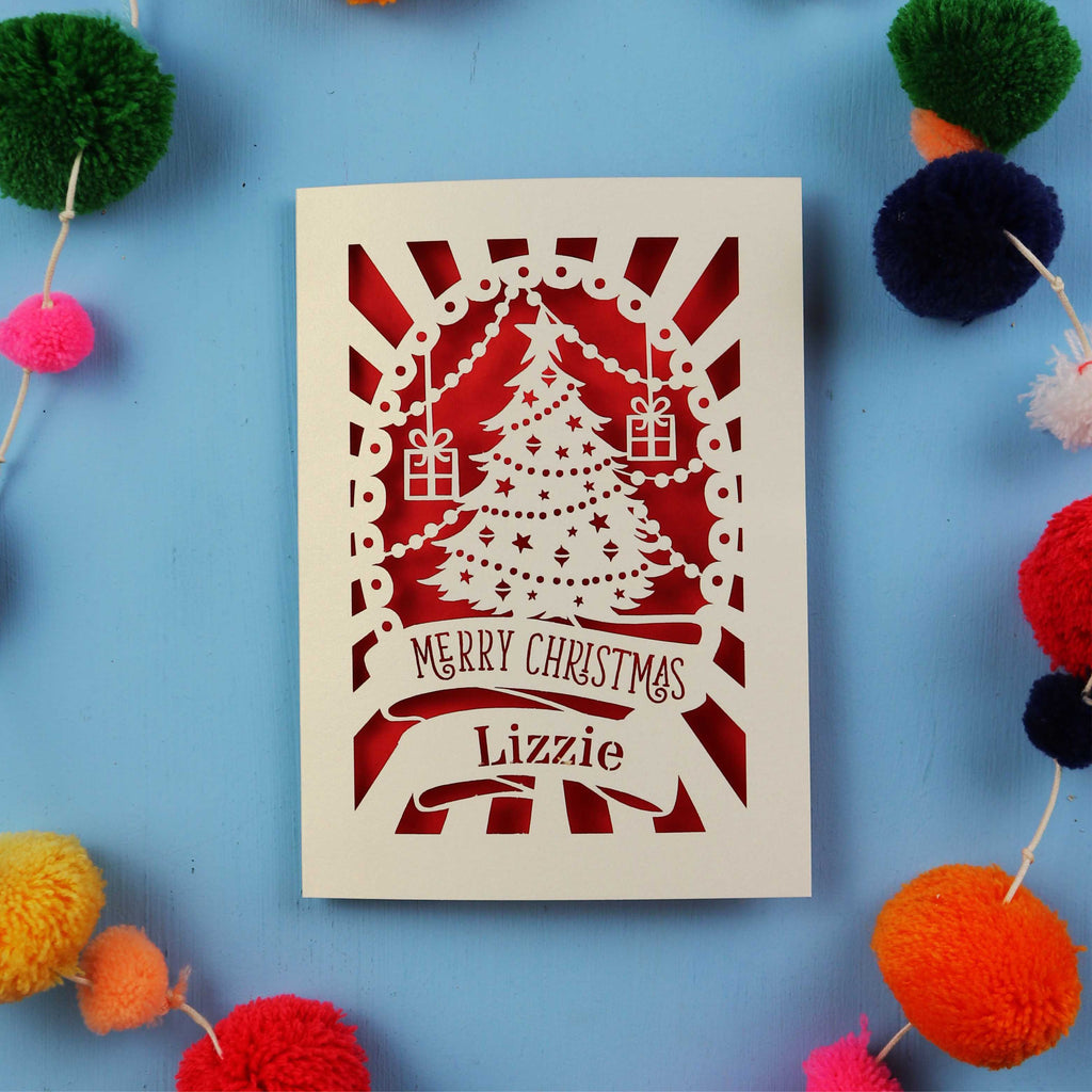 Laser cut Christmas card with decorative elements on a blue background