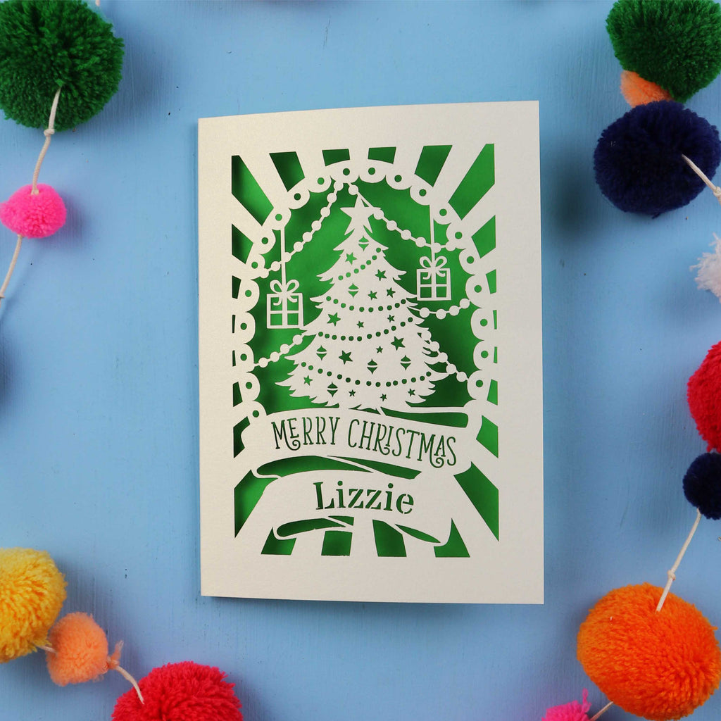 Laser cut Christmas card with decorative elements on a blue background