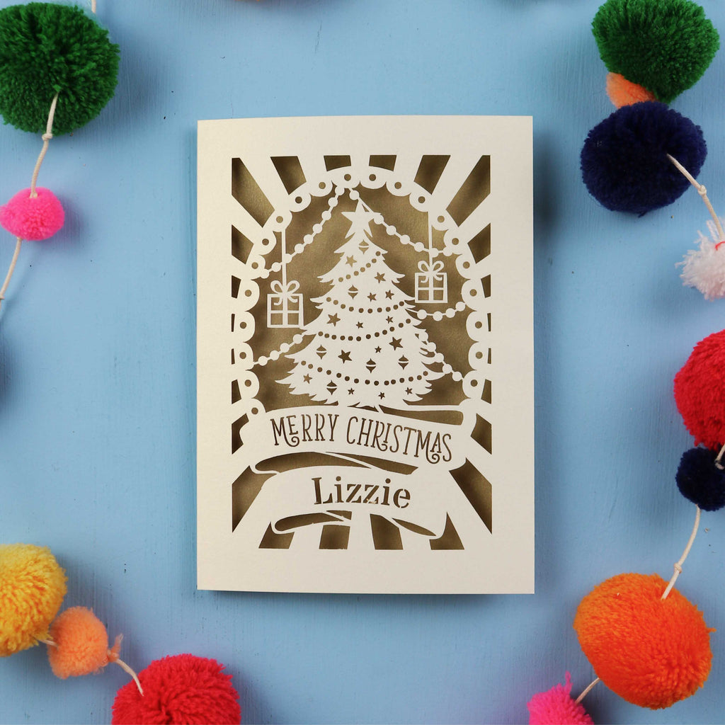 Laser cut Christmas card with decorative elements on a blue background
