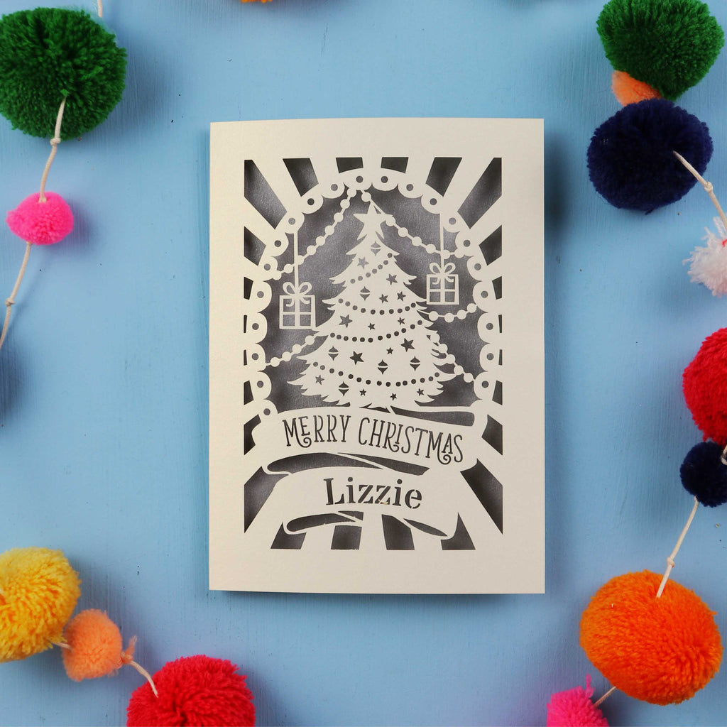 Laser cut Christmas card with decorative elements on a blue background