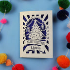 Laser cut Christmas card with decorative elements on a blue background