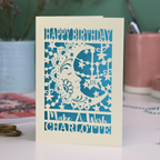 Laser cut moon 18th Birthday card with blue star and moon design on a desk with stationery items.