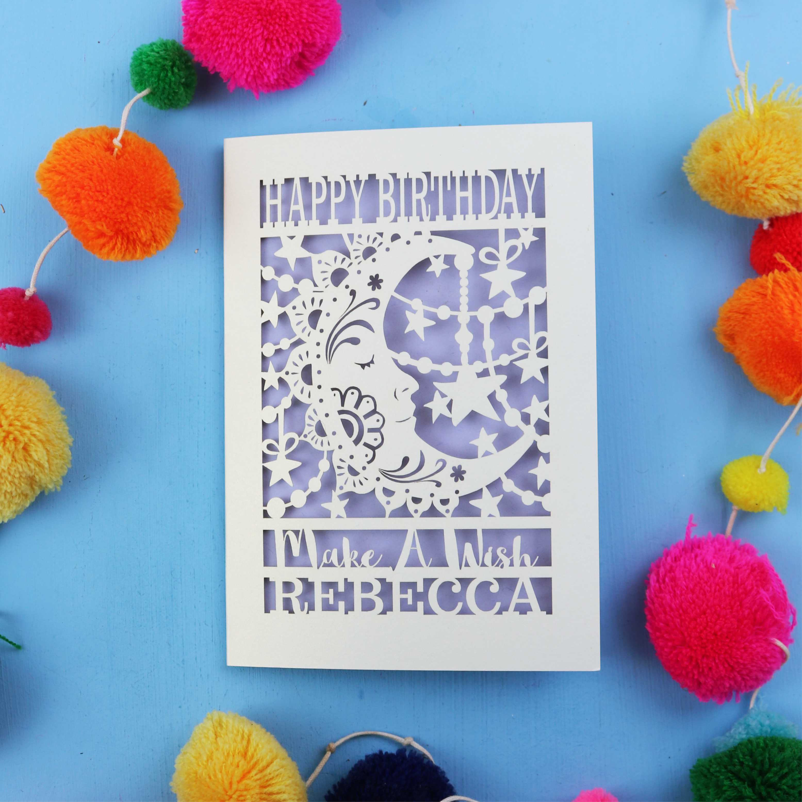 Personalised papercut Birthday card with decorative elements on a blue background