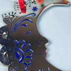 A silver and blue crescent moon Christmas tree ornament