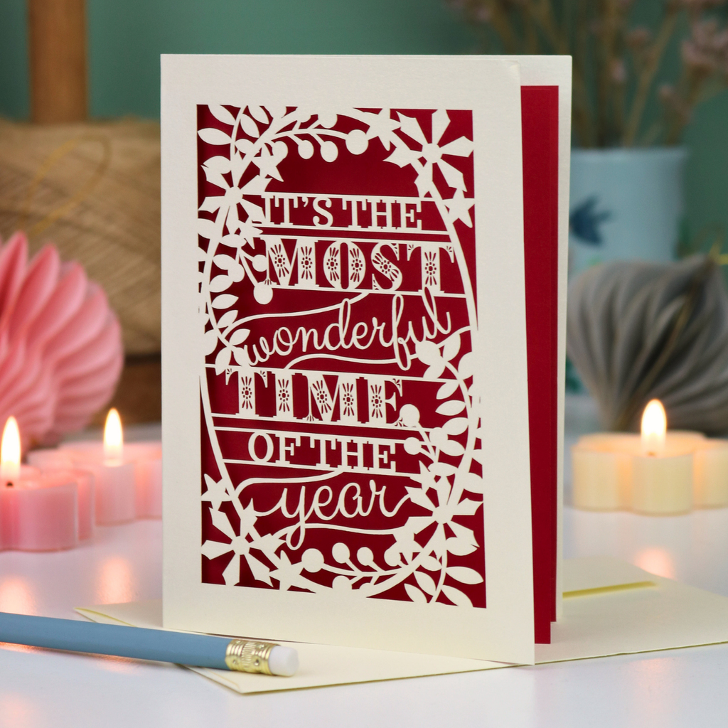 A laser cut Christmas card in cream with decorative text, 'It's the most wonderful time of the year'