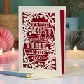 A laser cut Christmas card in cream with decorative text, 'It's the most wonderful time of the year'