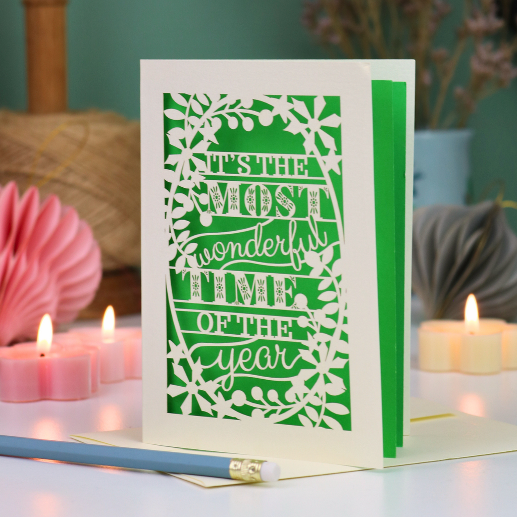 A laser cut Christmas card in cream with decorative text, 'It's the most wonderful time of the year'